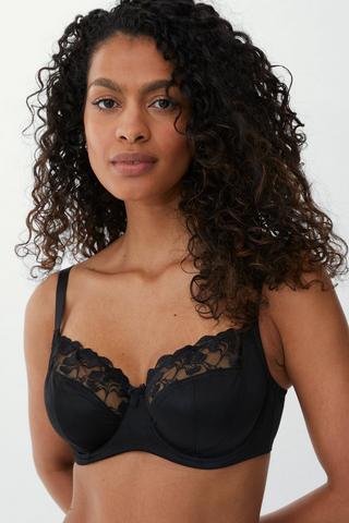 Premium Photo  Modern and trendy lingerie store interior a row of black  and white and beige bras are hanging in a