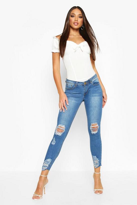 boohoo Mid Rise Distressed Knee And Ankle Skinny Jeans 1